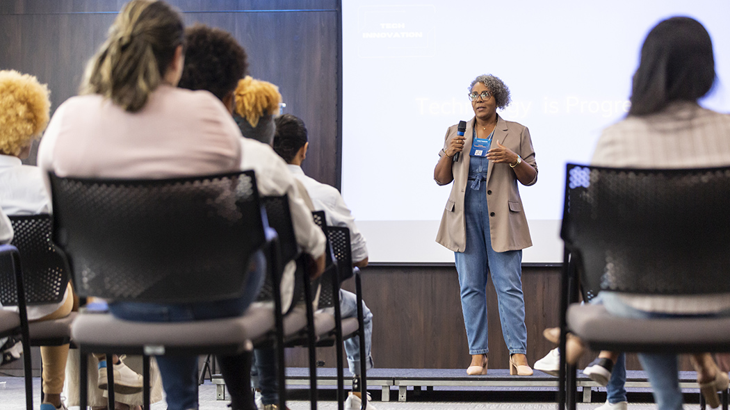 Business woman giving talk to business audience.