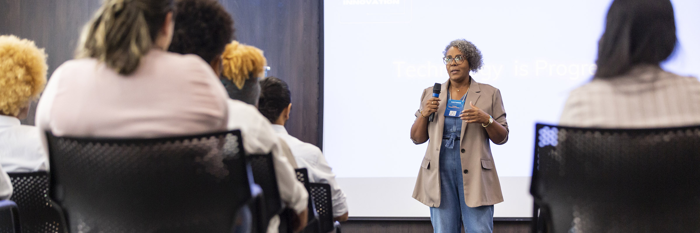 A woman gives a presentation to a business conference.