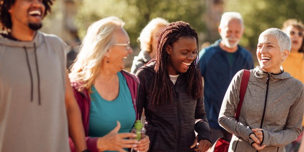 Four people walking and laughing