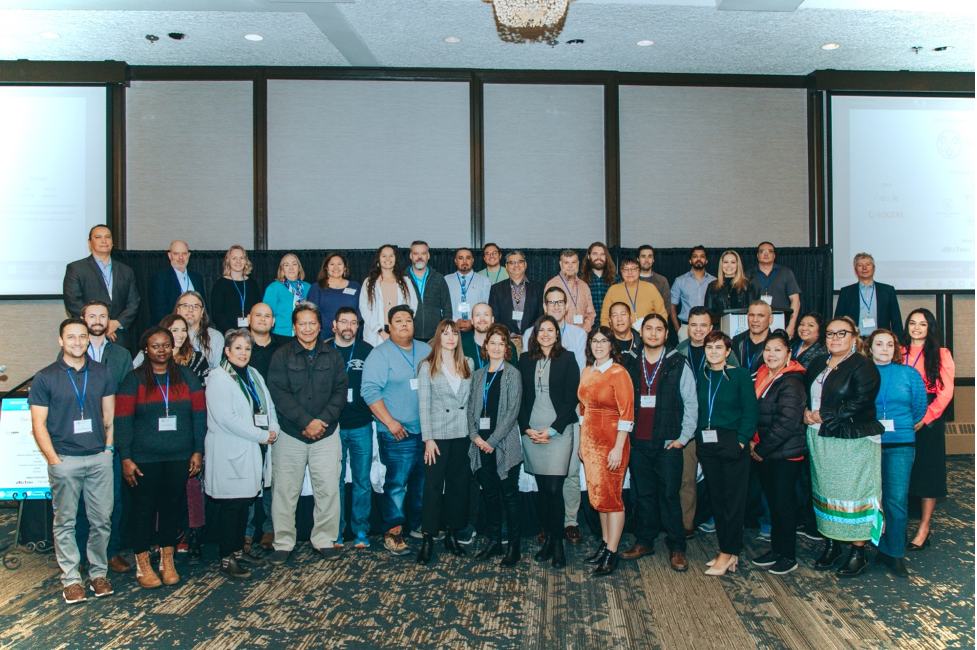 Attendees at the conference pose in a group photo