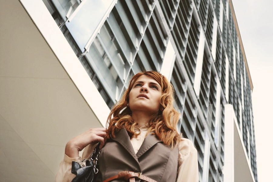 Female in front of high rise building