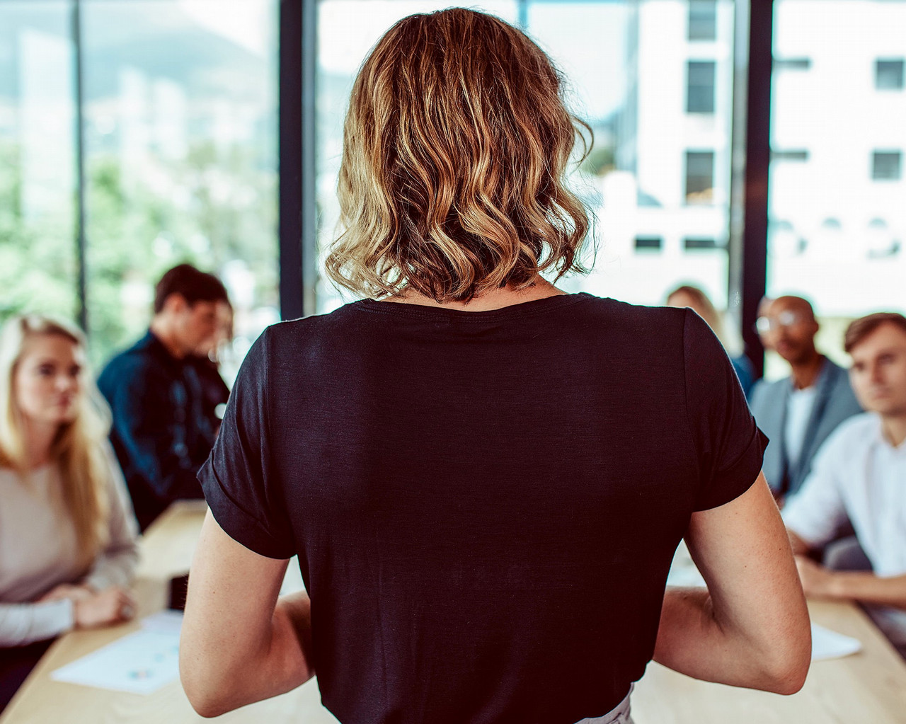 female standing at a business meeting