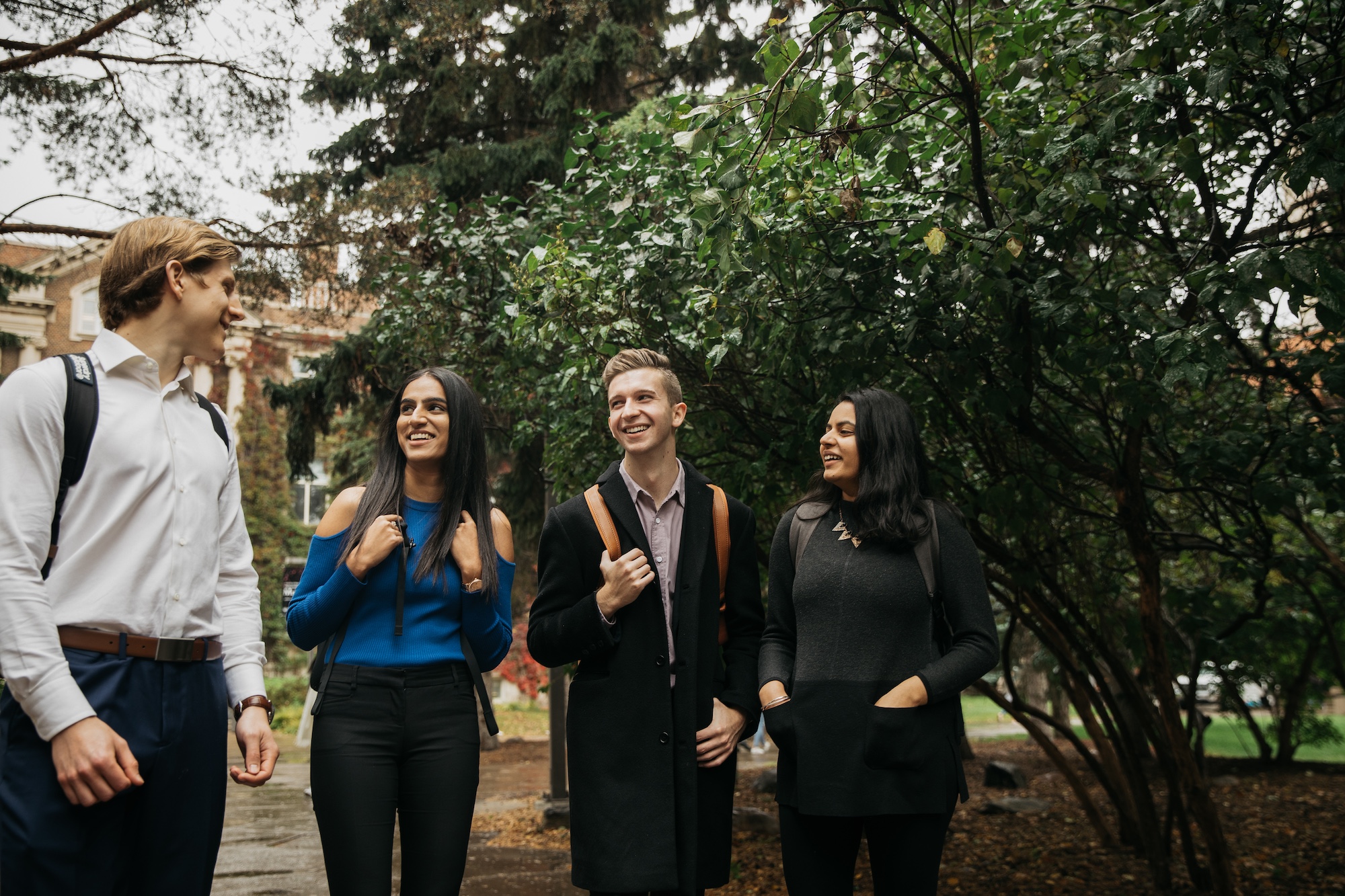 Four students walking and discussing