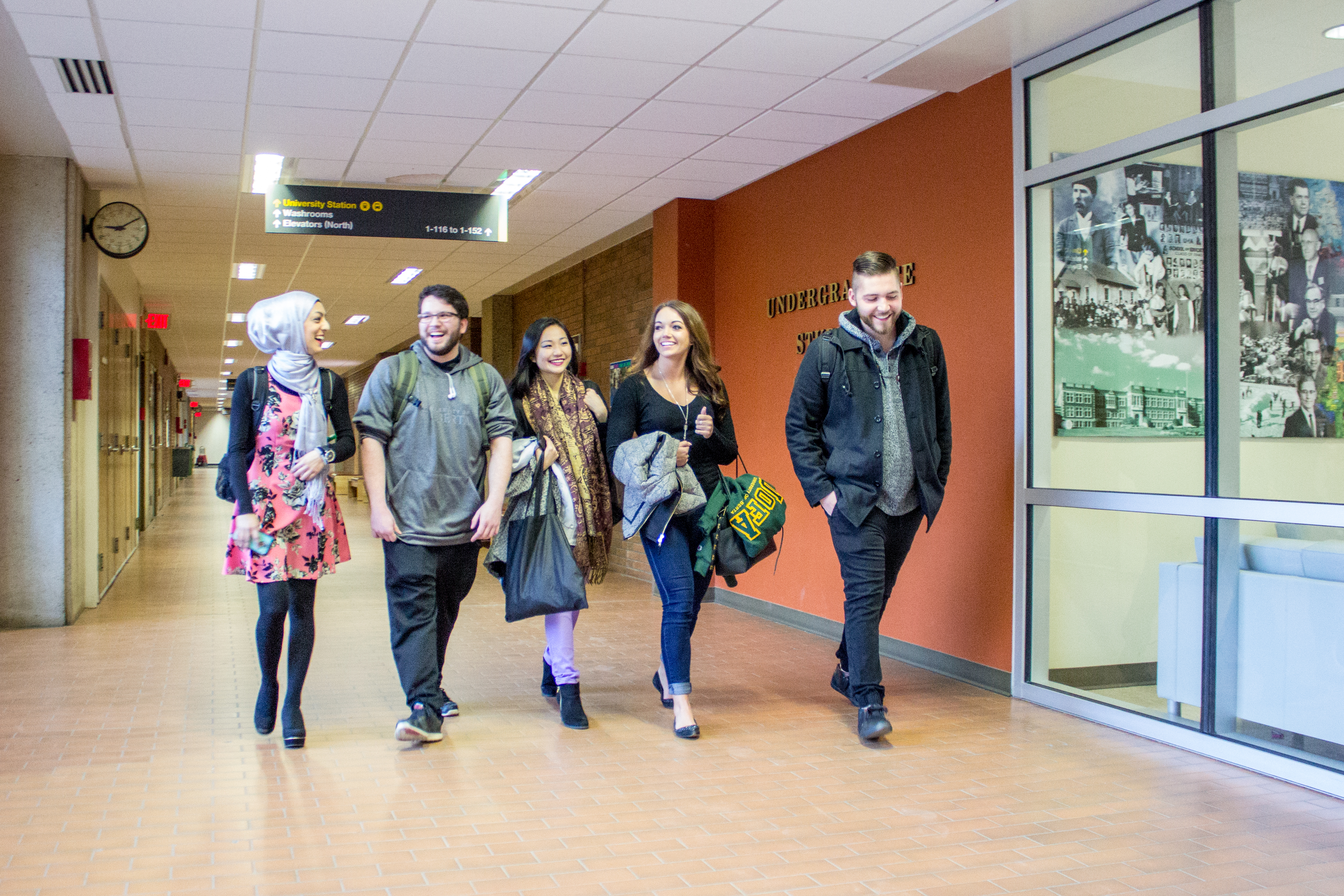 group of students walking together outside of Education Student Services Office