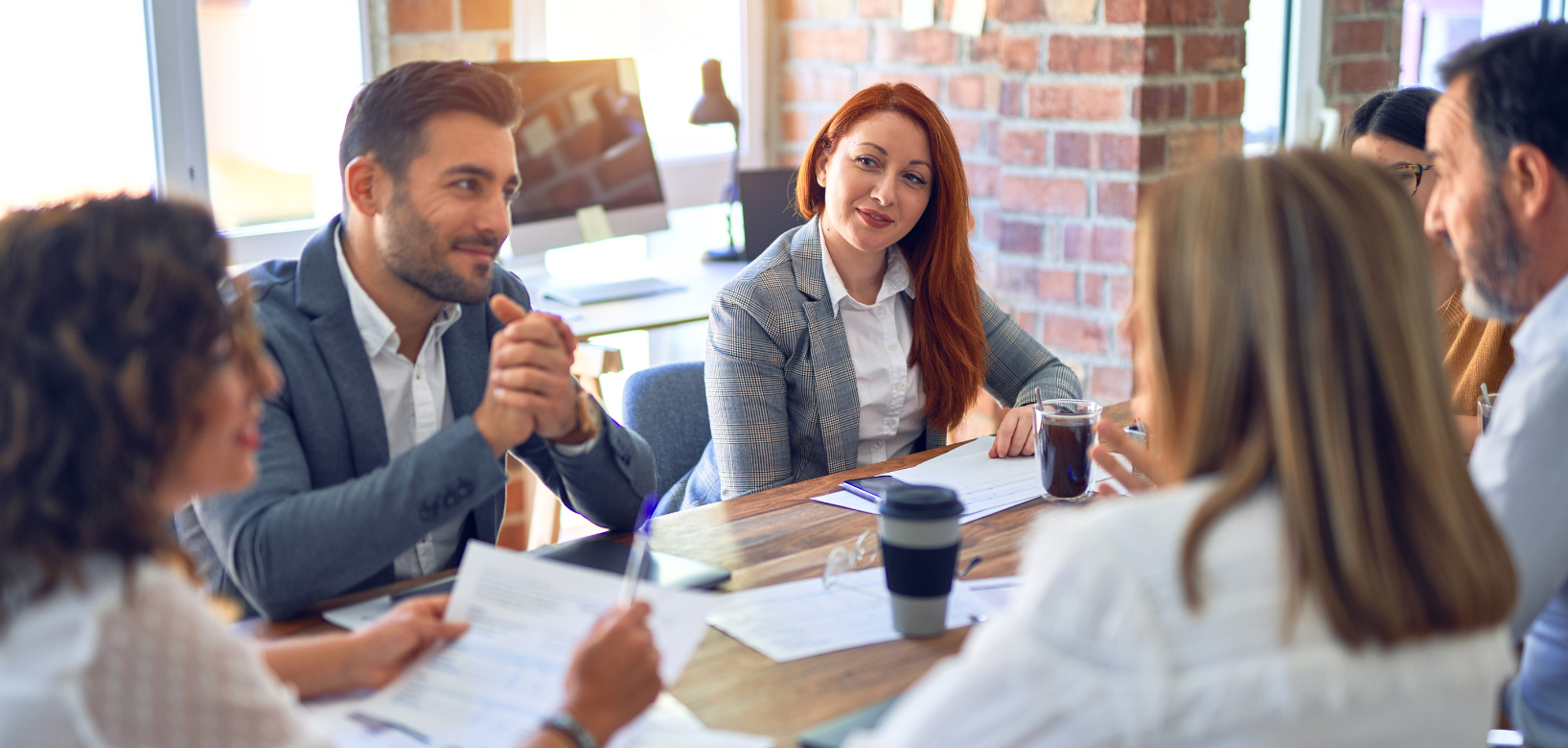 Group of people sitting around table chatting