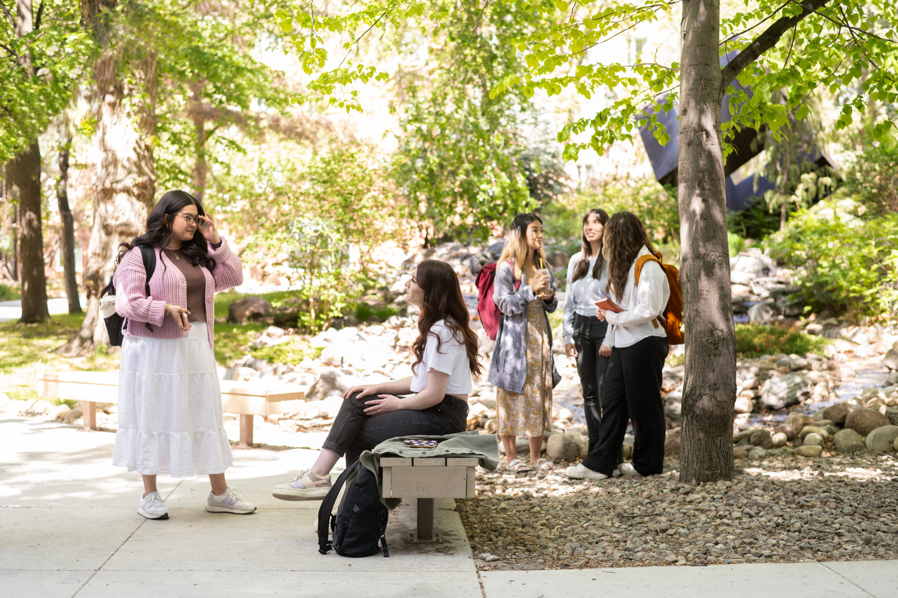 Students talking outside by Education Cube