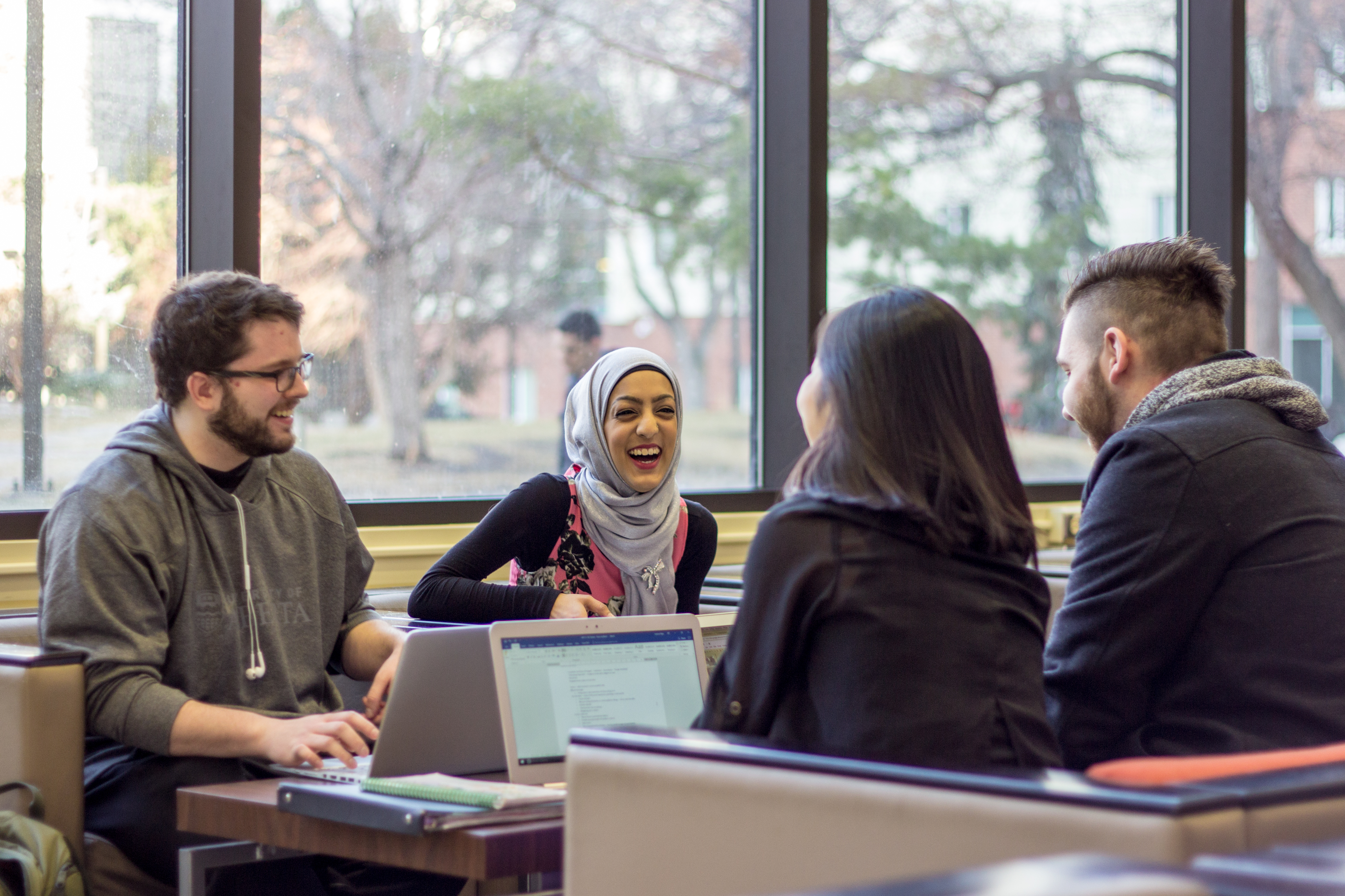 Group of students sitting together laughing