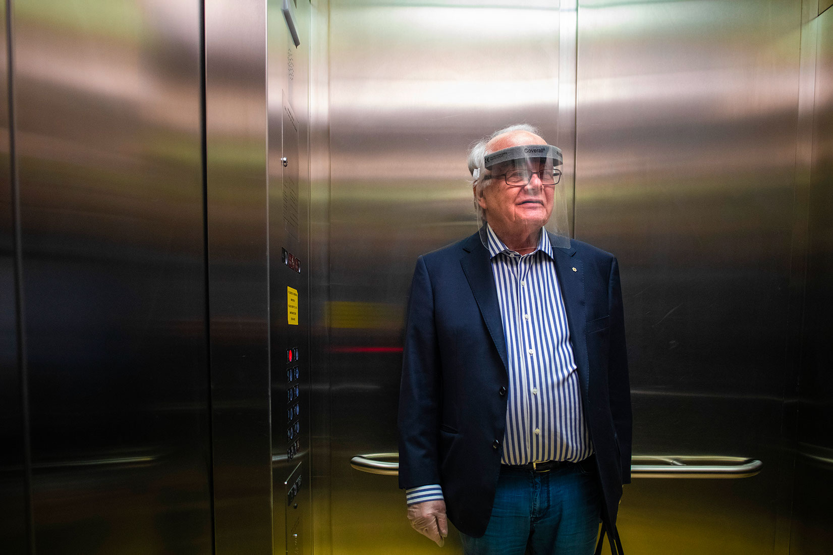 Picture of Lorne Tyrell in an elevator wearing a face shield