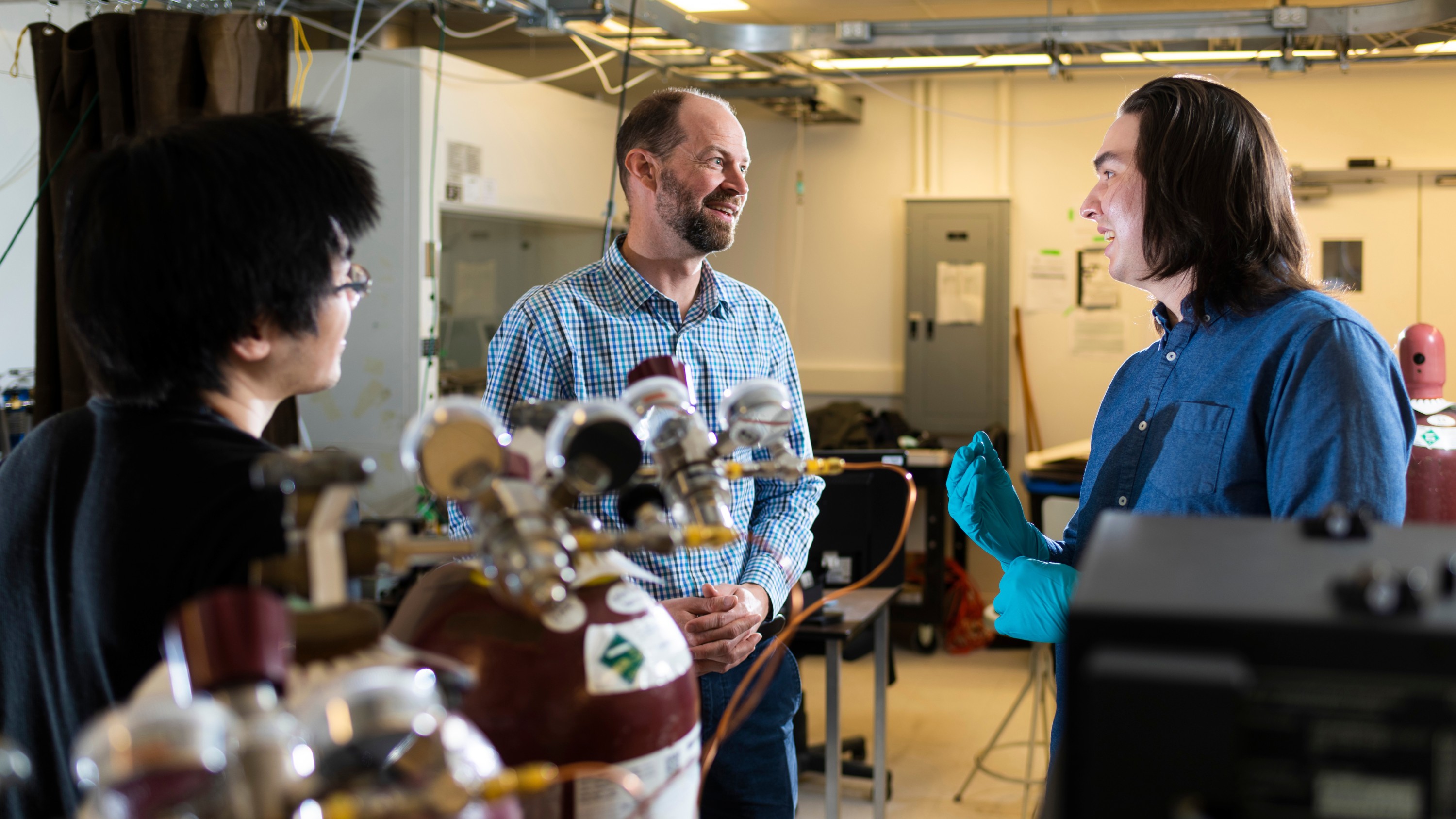 Engineering professor Jason Olfert (centre) with laboratory technician Kerry Chen (left) and former student James Tatum, who now works for Innova Hydrogen, at the Nanotechnology Research Centre on April 11, 2022