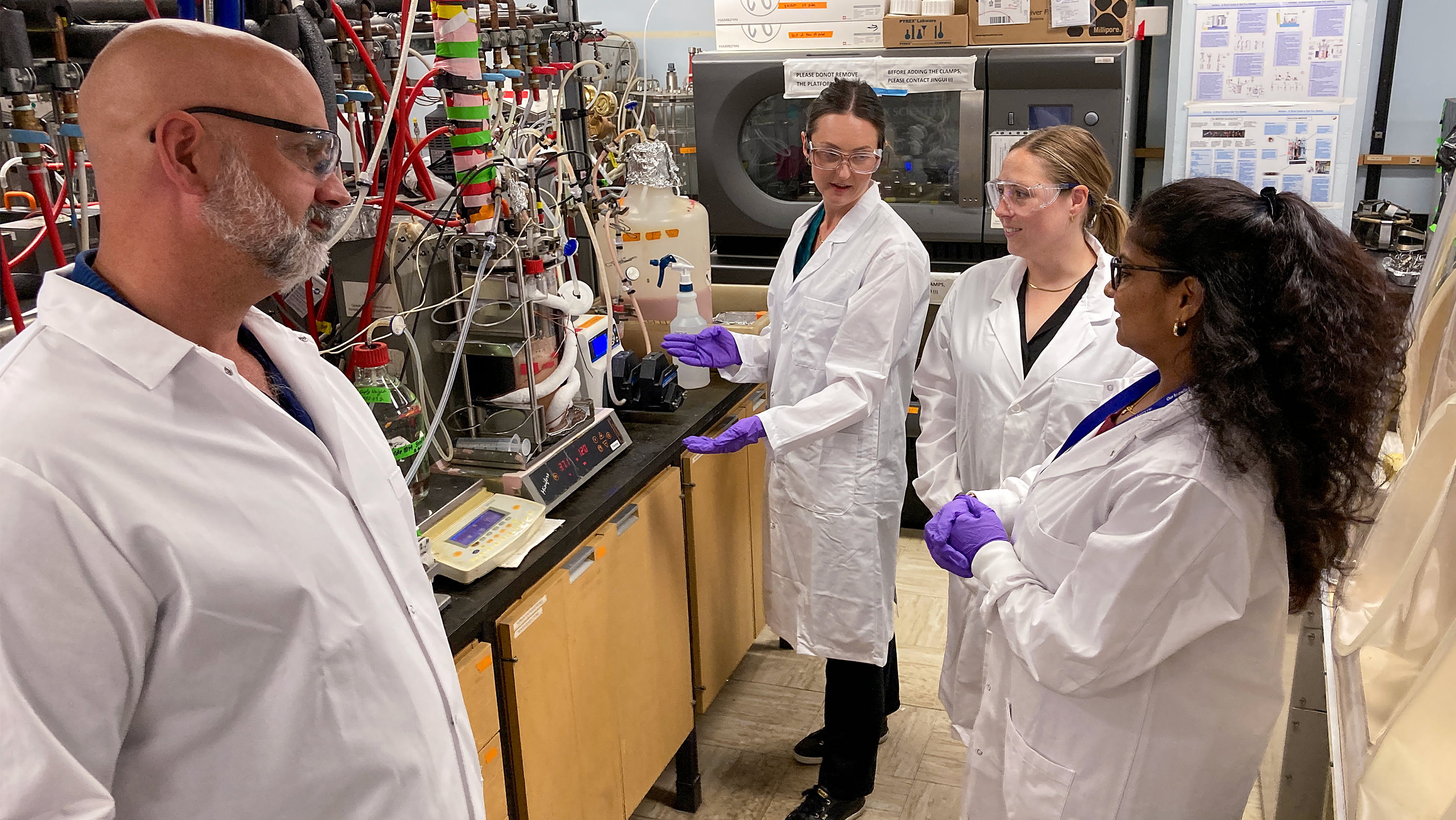 U of A bioresource scientist David Bressler, MSc student Haley Wolgien-Lowe, Cv̄ictus director of biotechnology and carbon reduction Katrina Stewart and post-doctoral researcher Sapna Indrakumar work with a fermenter in Bressler’s lab. 