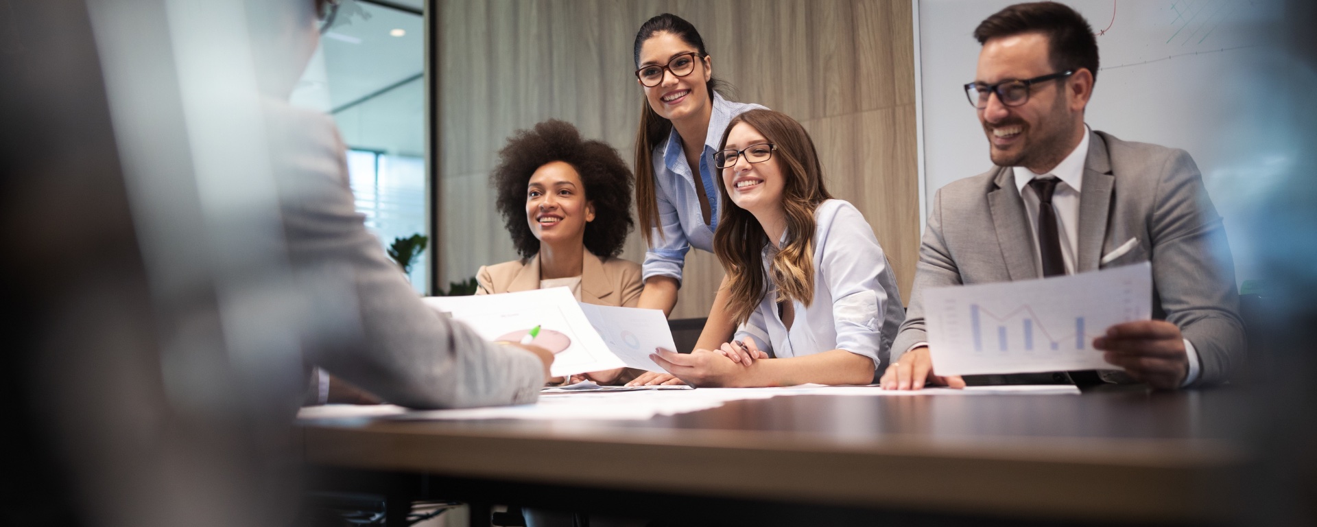 People sitting around a desk smiling