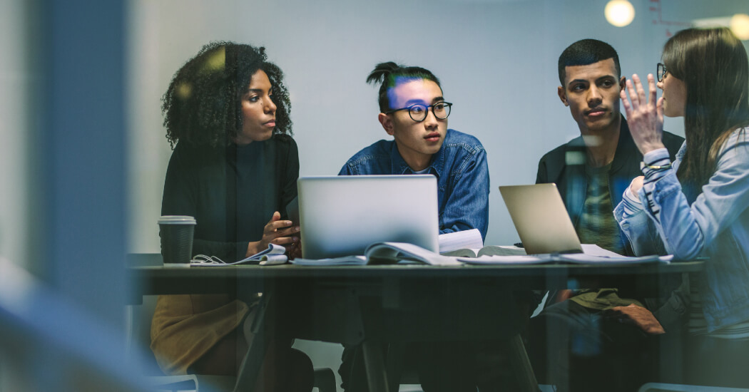 Four people having a meeting