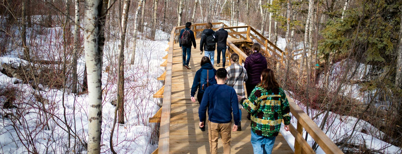 Eric Adams, Professor, Faculty of Law, leads a group of students on a river valley walk