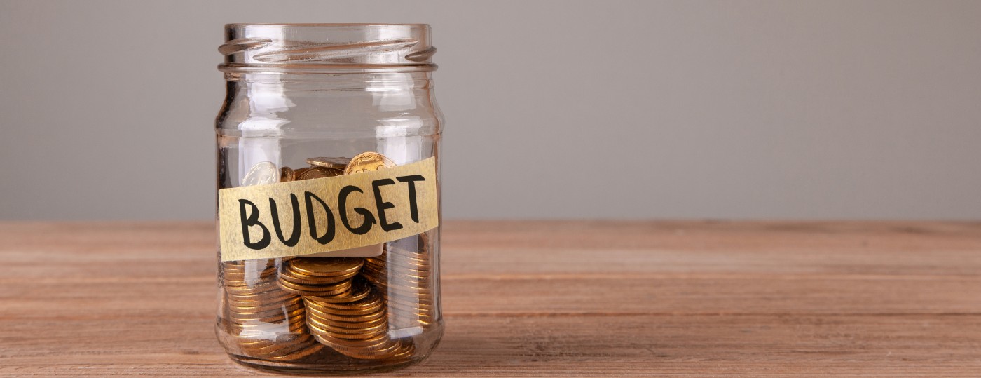 jar that has tape that says budget with pennies inside