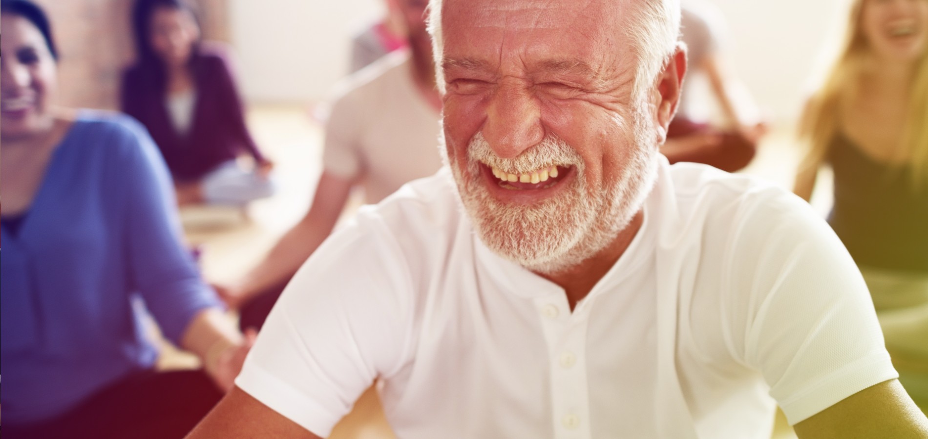 Man sitting crosslegged smiling