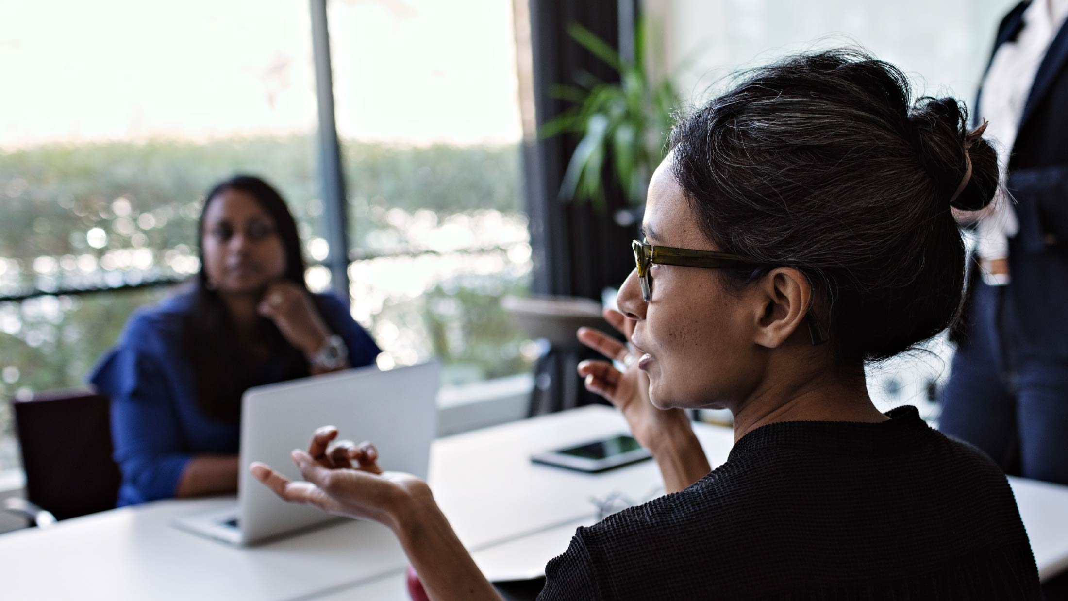 businesswoman addresses colleagues