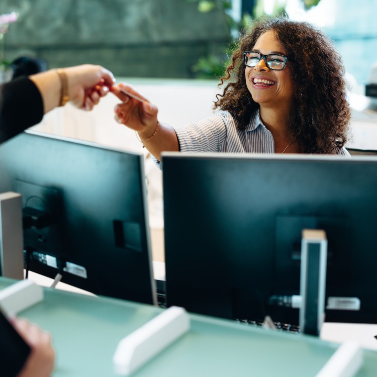 woman handing a card to someone