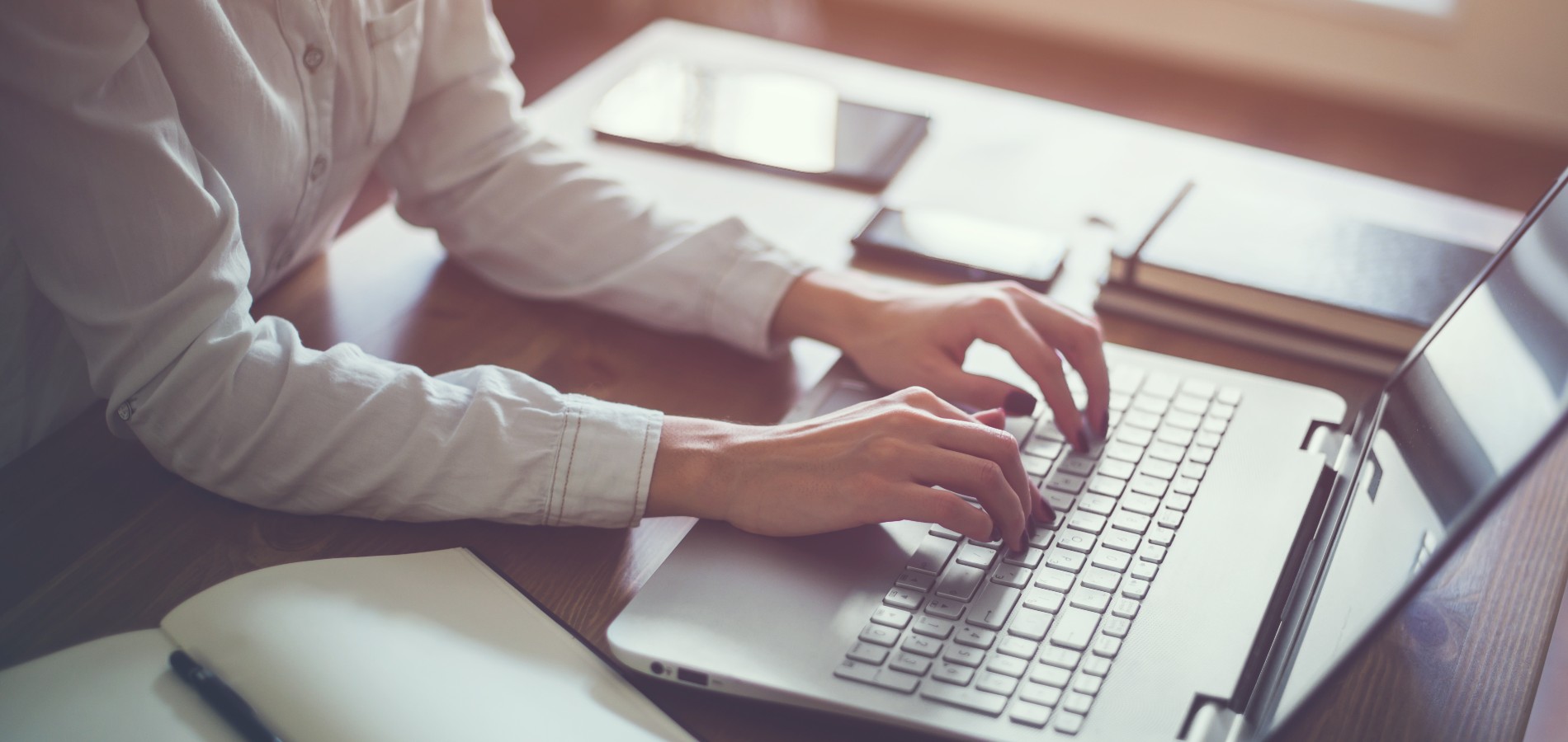 person writing on a laptop