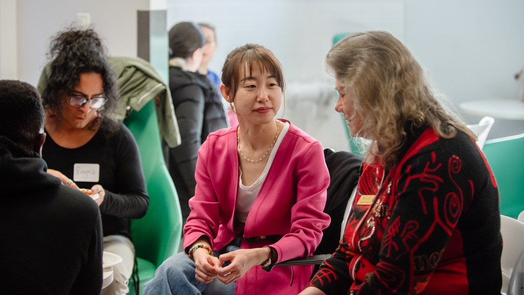 Academic visitors sit and talk in SUB basement.