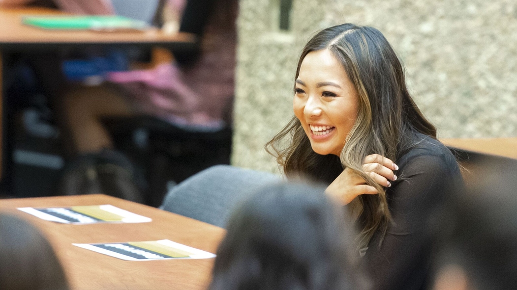 An individual laughs while at a leadership breakout session with others.