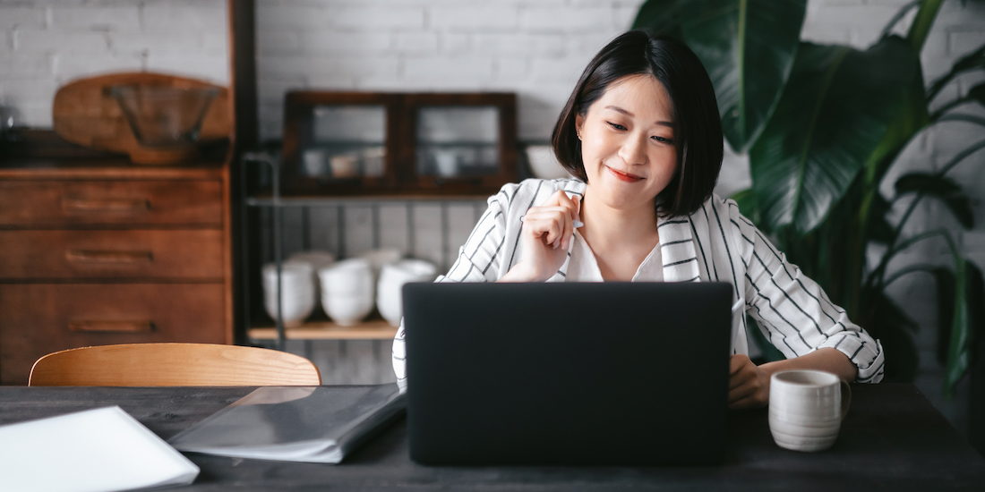 Student smiling at her laptop