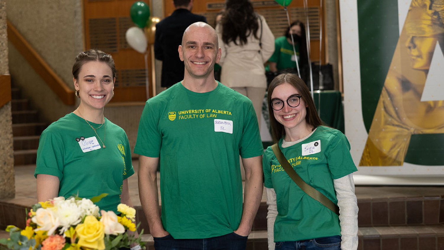 Three students smiling for camera