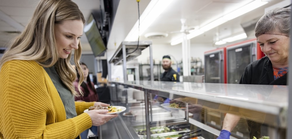 Woman queueing in a cafeteria