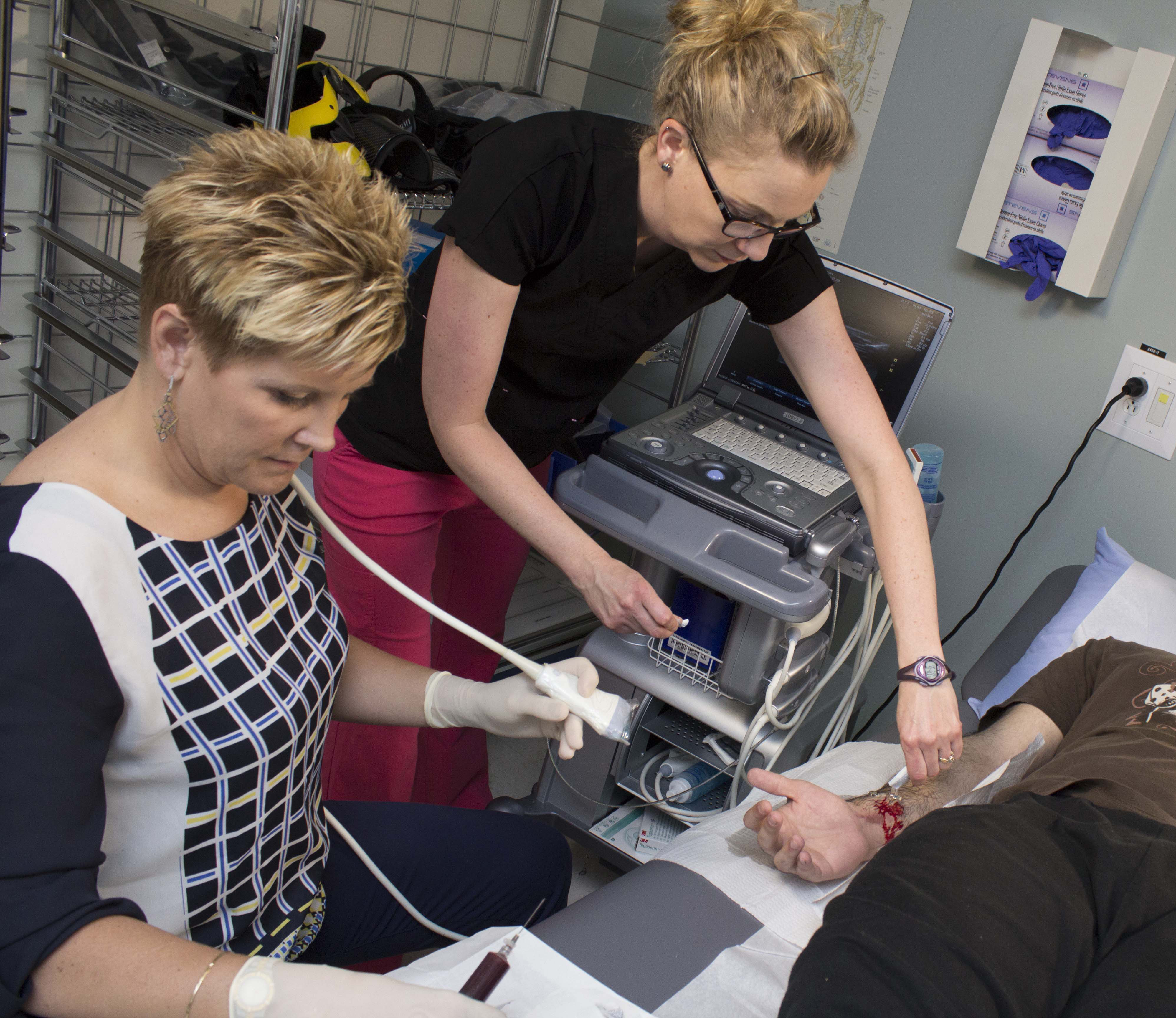 Sports medicine physician, Marni Wesner, performs PRP injection on a patient.