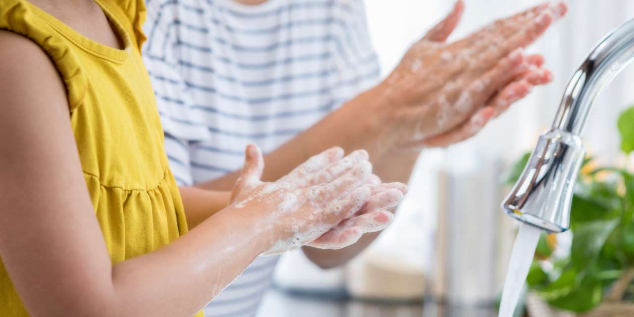 Two people washing their hands