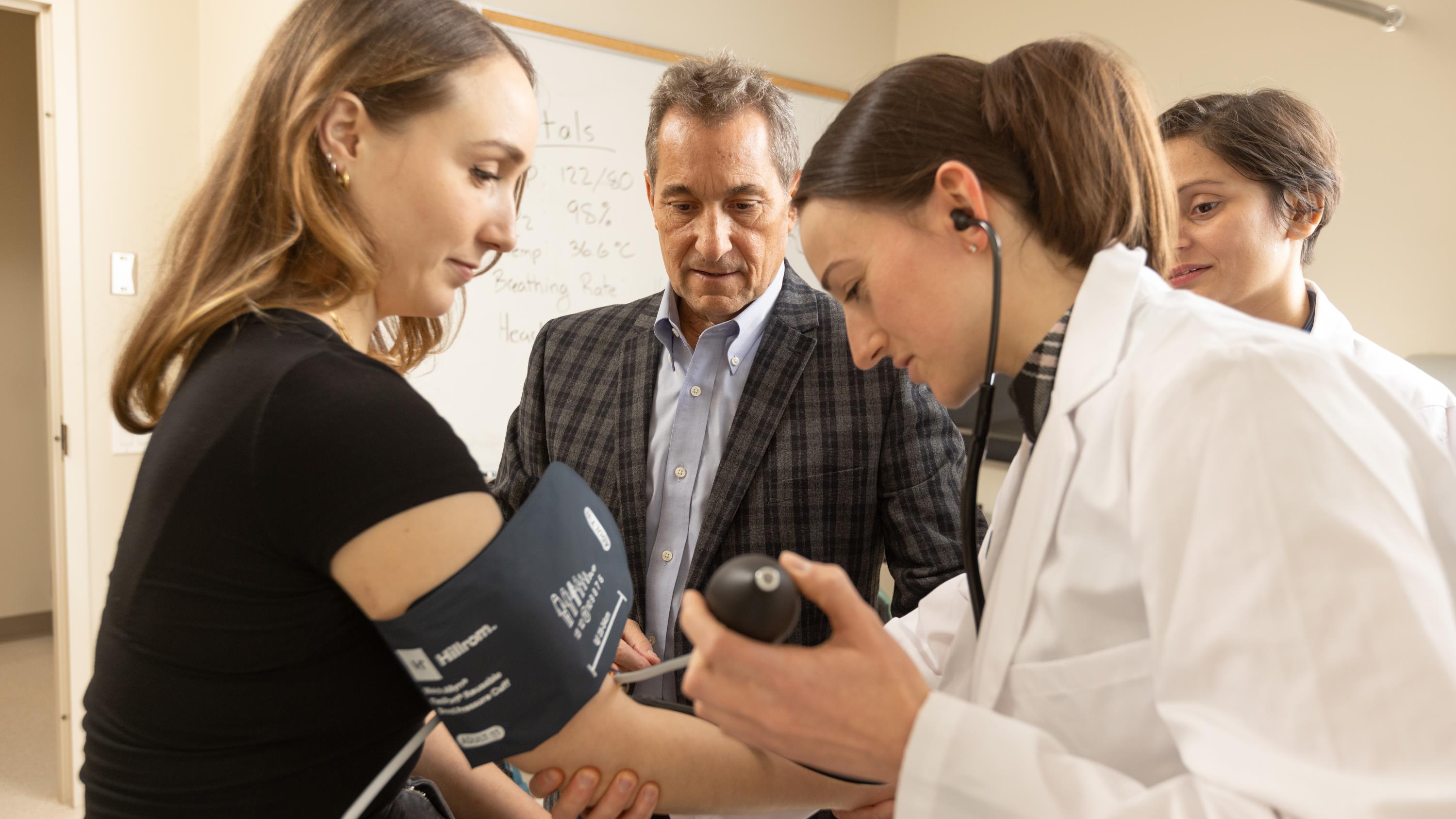 Doctor checking patients blood pressure