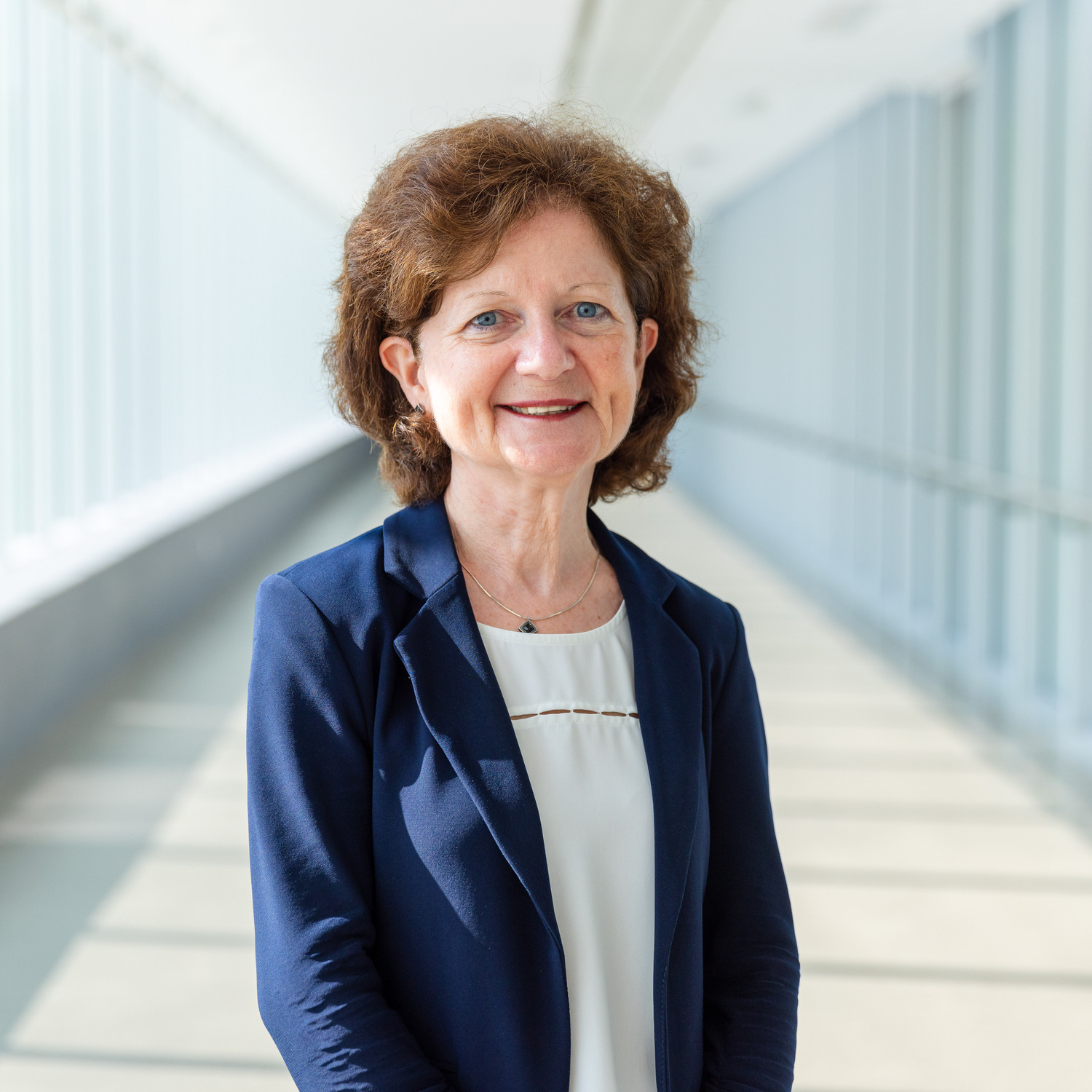 A headshot of Brenda Hemmelgarn, Dean of the Faculty of Medicine & Dentistry, in a sunny pedway.