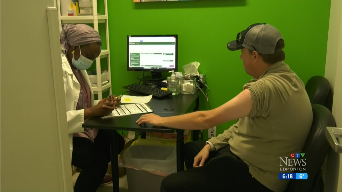 Image of patient getting a flu shot from a medical practitioner