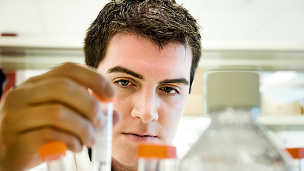 Man holding test tubes