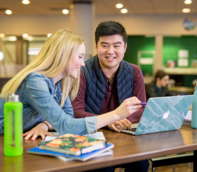 two people working with laptop in Lister Dining Hall