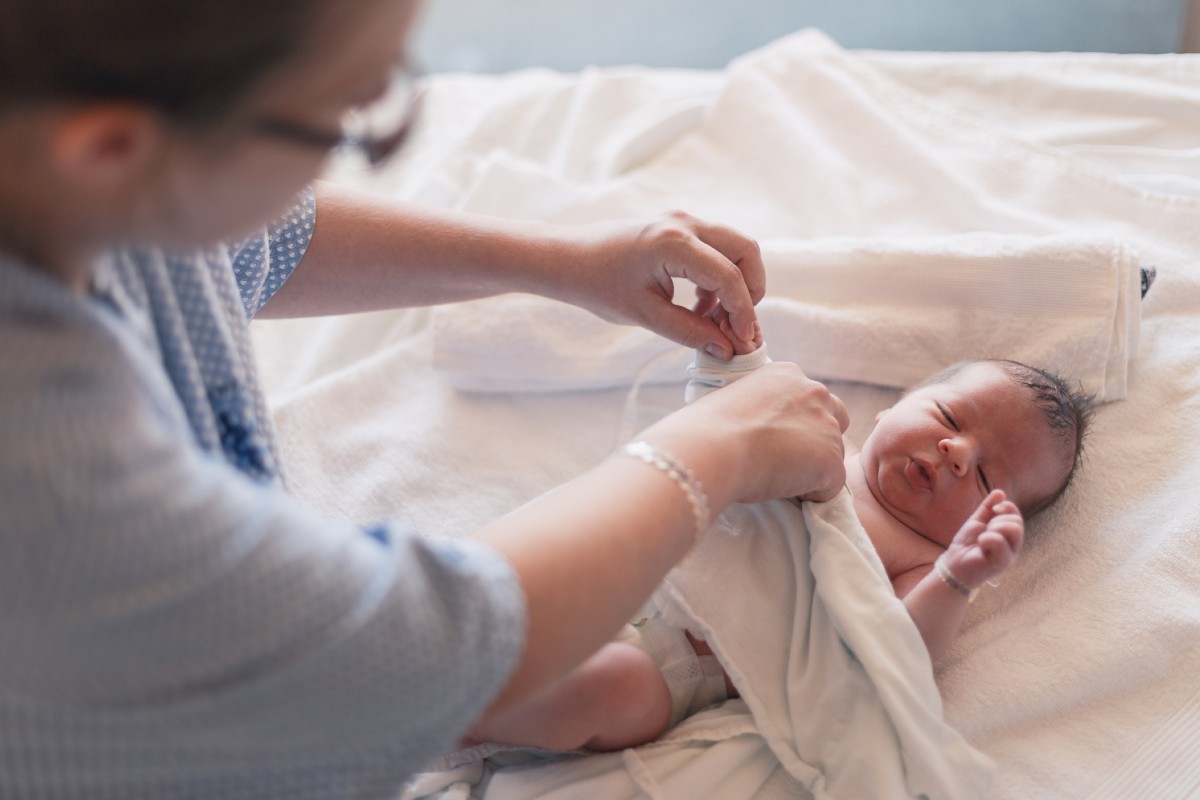 A parent changing a newborn baby's diaper.