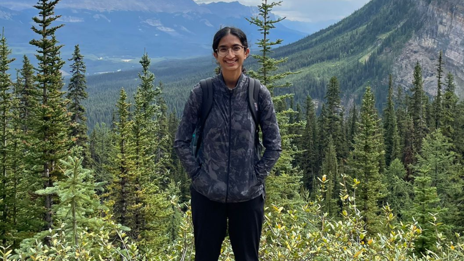 Portrait of Cindy in front of mountains.